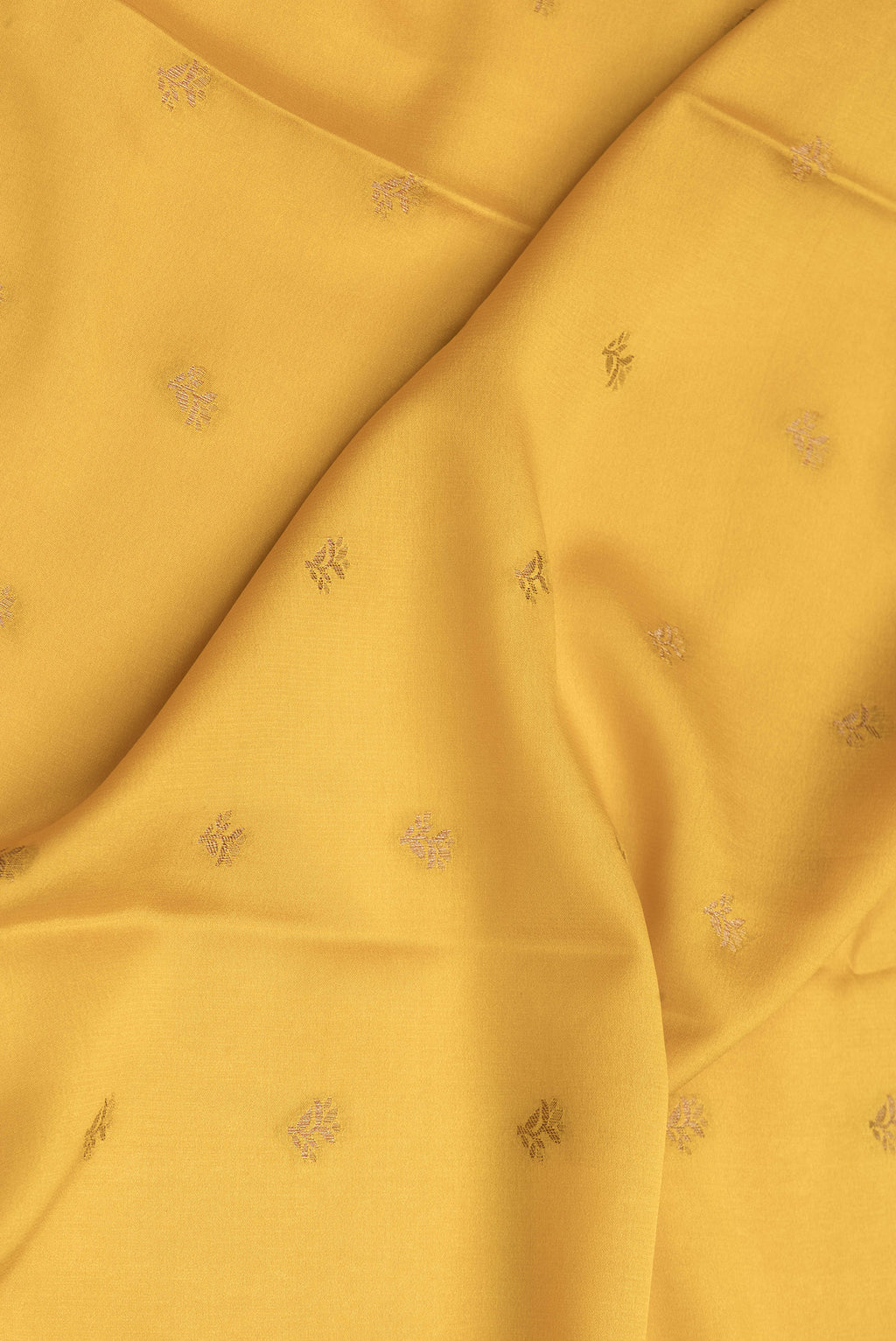 Close up of Mustard Dual Tone Mysore Crepe Saree with Zari Butta on the body and Zari Border.  displaying folds
