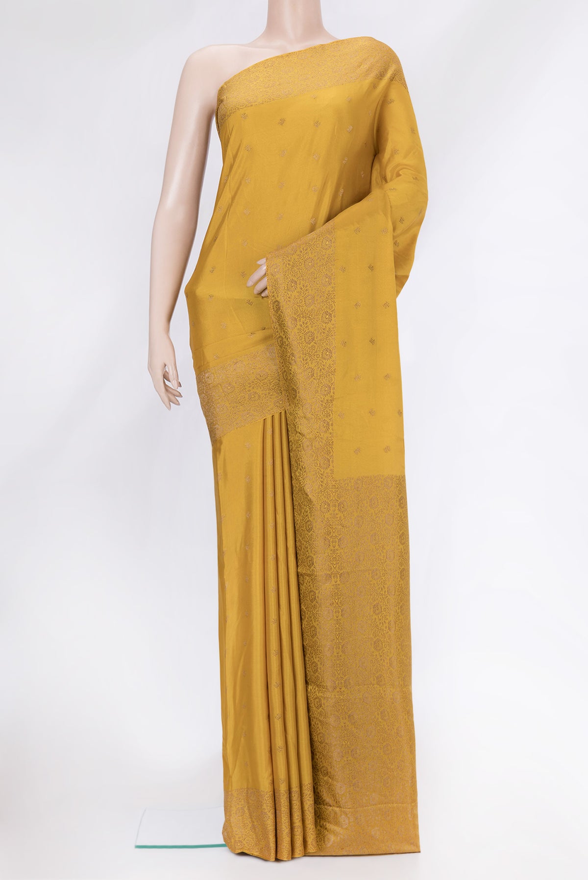 Mustard Dual Tone Mysore Crepe Saree with Zari Butta on the body and Zari Border.  displayed on a mannequin