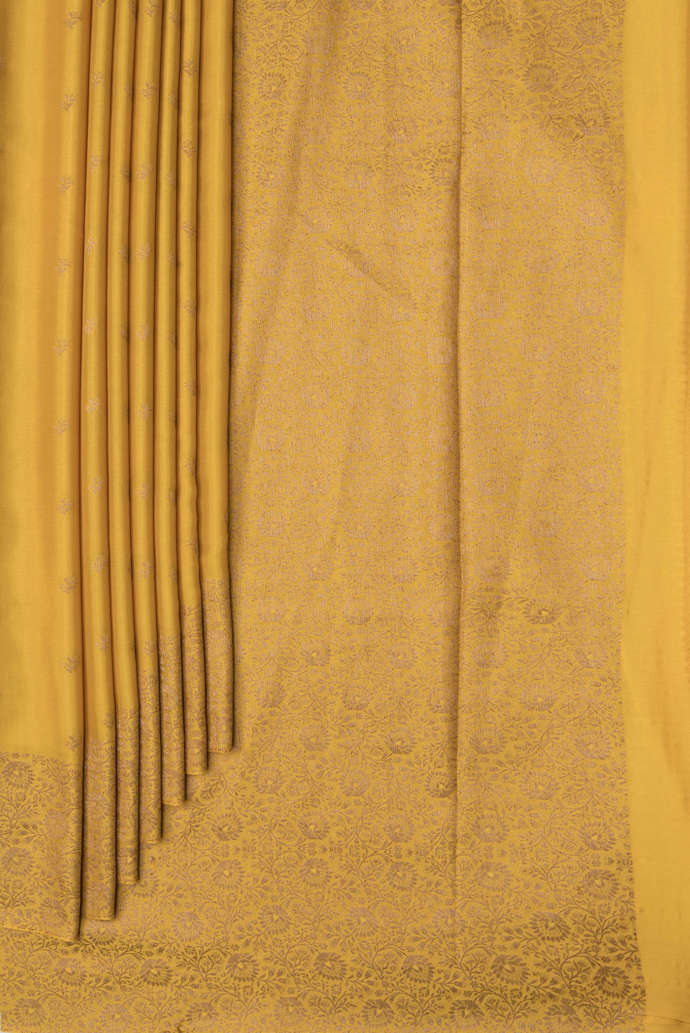Pleats and pallu of Mustard Dual Tone Mysore Crepe Saree with Zari Butta on the body and Zari Border. 