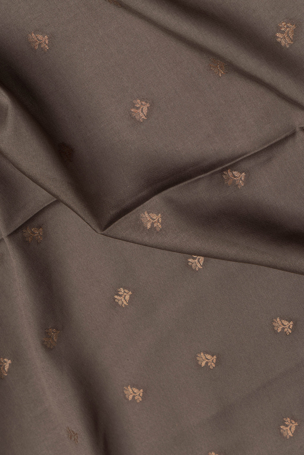 Close up of Brown Dual Tone Mysore Crepe Saree with Zari Butta on the body and Zari Border.  displaying folds