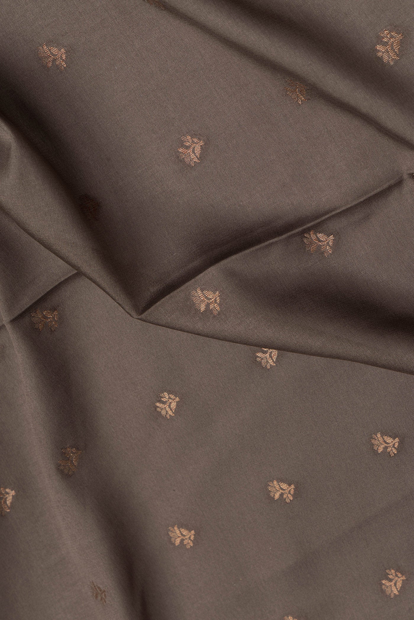 Close up of Brown Dual Tone Mysore Crepe Saree with Zari Butta on the body and Zari Border.  displaying folds