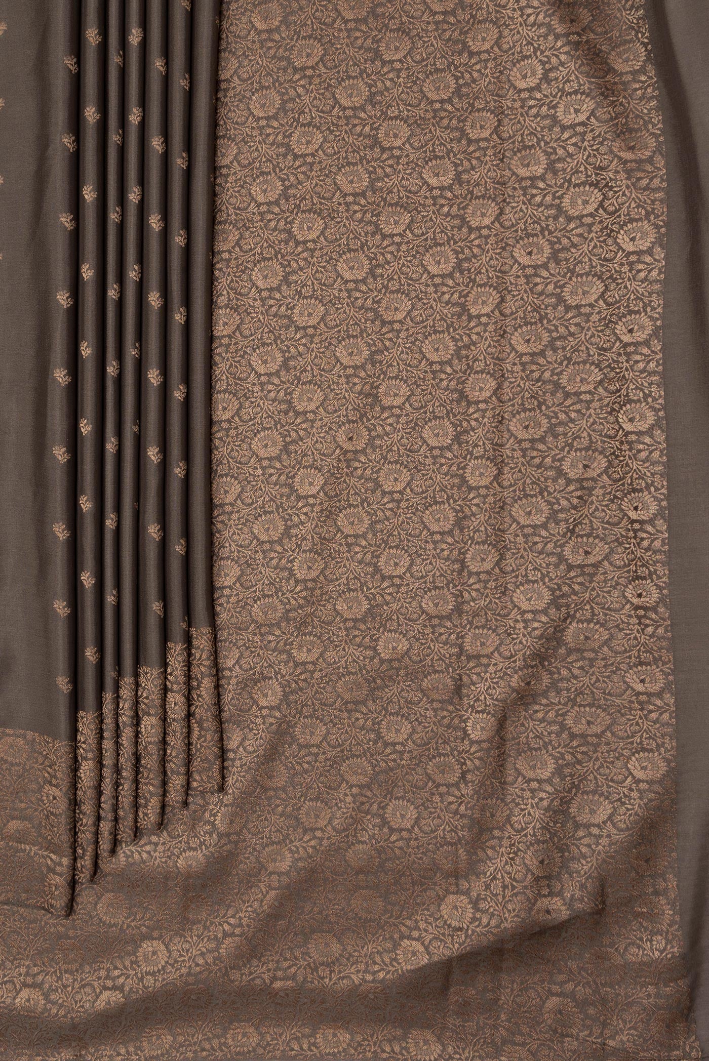 Pleats and pallu of Brown Dual Tone Mysore Crepe Saree with Zari Butta on the body and Zari Border. 