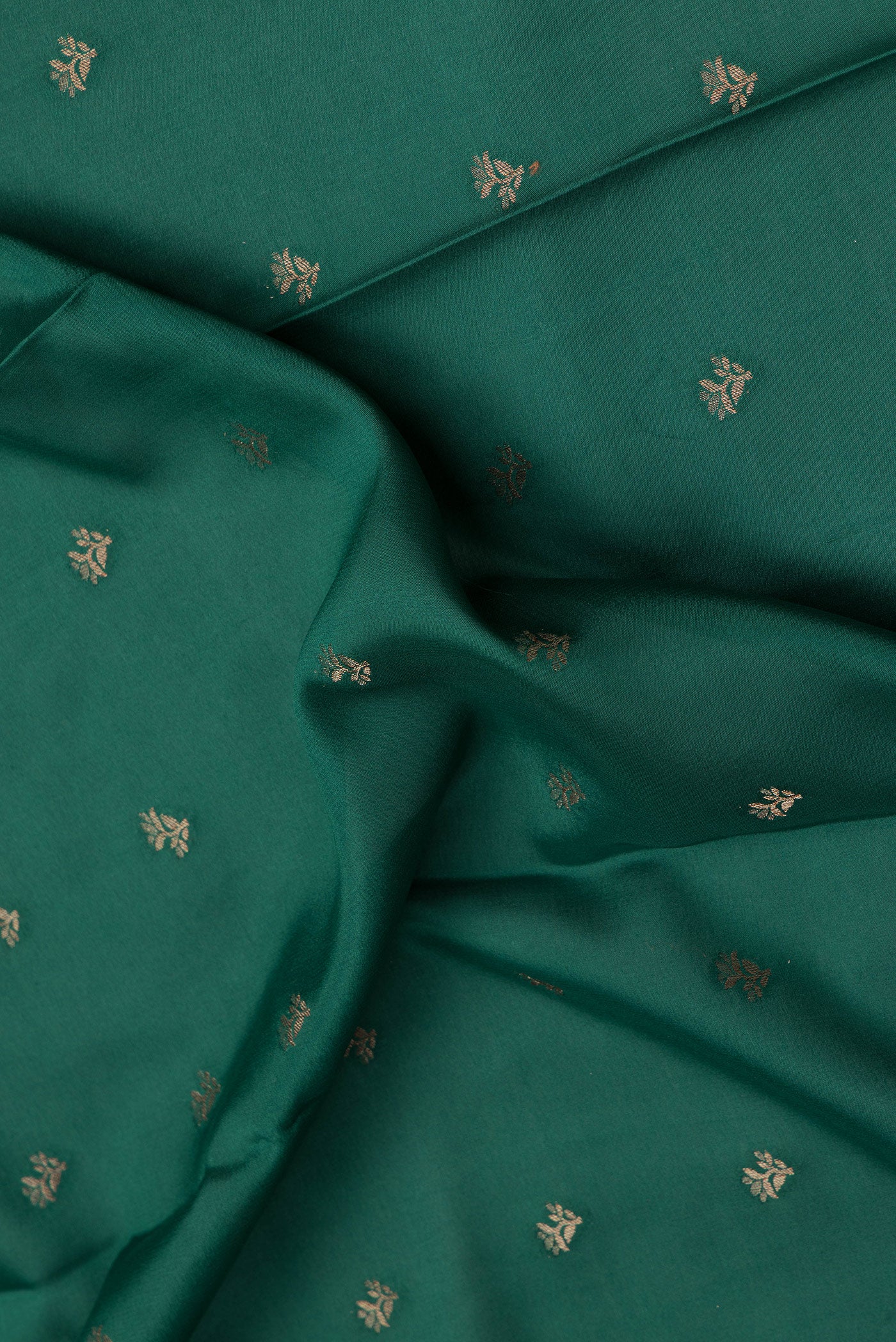 Close up of Bottle Green Mysore Crepe Saree with Zari Butta on the body and Zari Border.  displaying folds