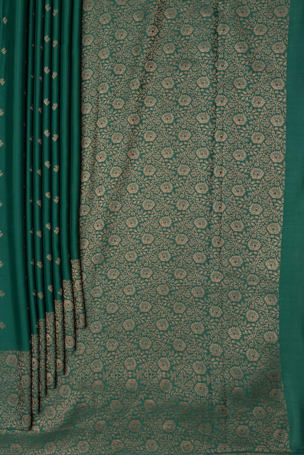 Pleats and pallu of Bottle Green Mysore Crepe Saree with Zari Butta on the body and Zari Border. 
