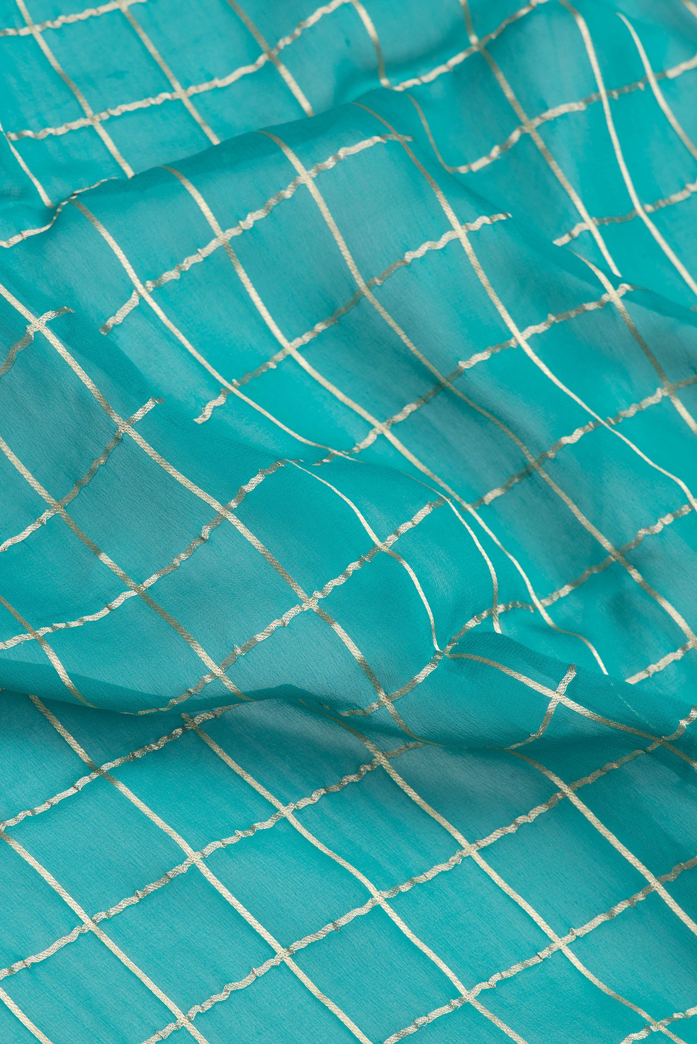 Close up of Peacock Blue Dual Tone Mysore Georgette Saree with Checked design on the body and Zari Border.  displaying folds