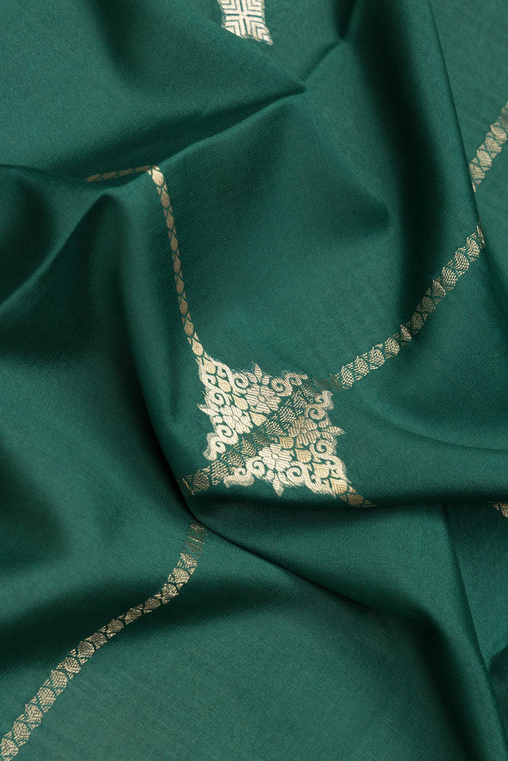 Close up of Bottle Green Dual Tone Mysore Silk Saree with Zari Butta on the body and Zari Border.  displaying folds