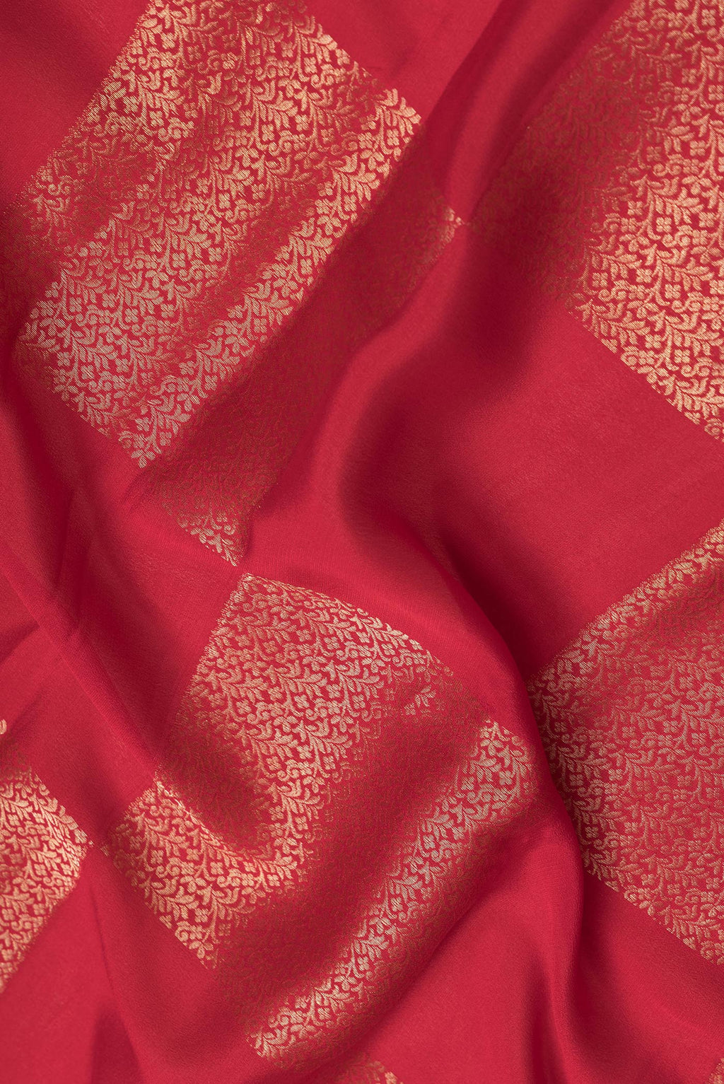 Close up of Red Dual Tone Mysore Georgette Saree with Zari Brocade on the body and Zari Border.  displaying folds