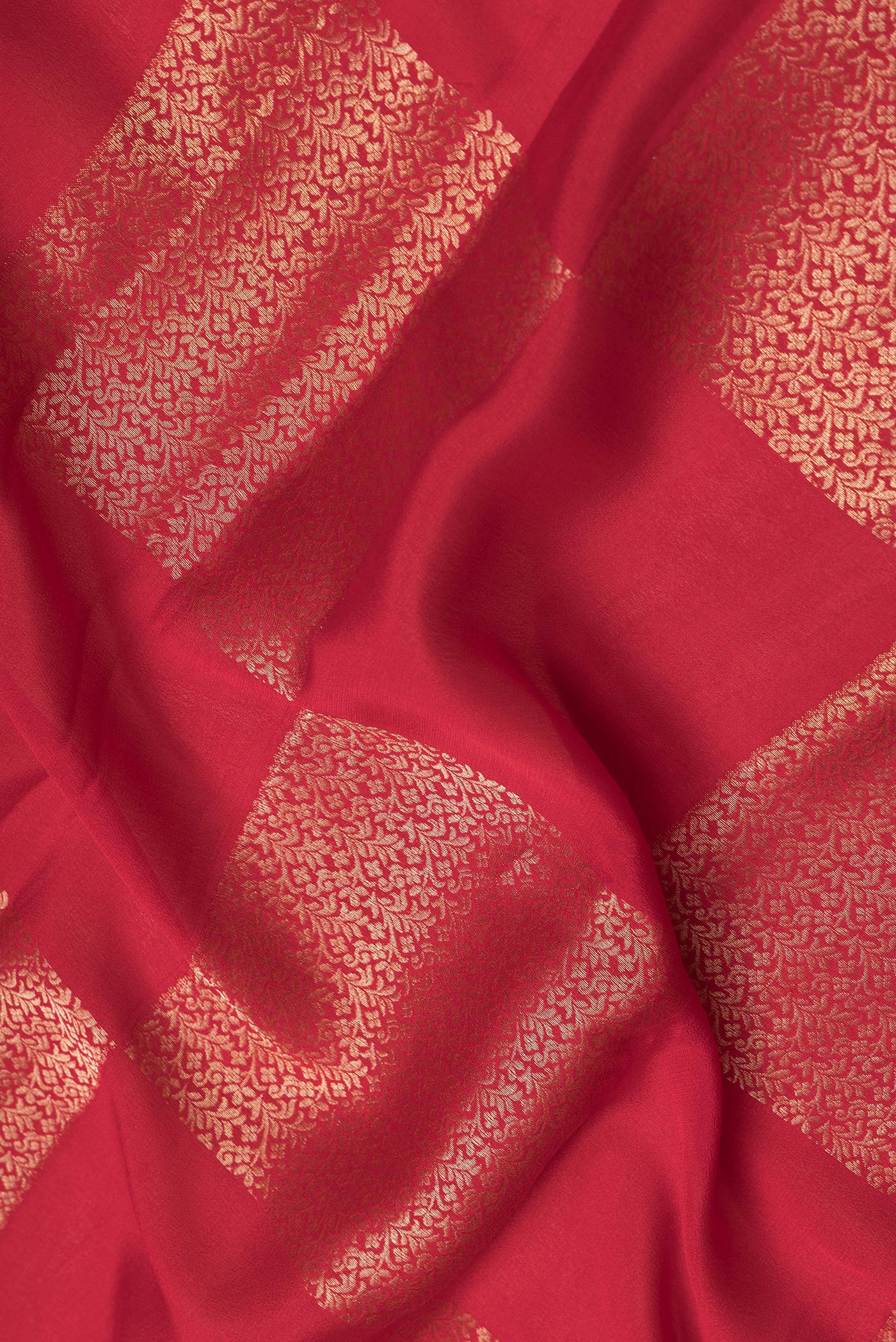 Close up of Red Dual Tone Mysore Georgette Saree with Zari Brocade on the body and Zari Border.  displaying folds