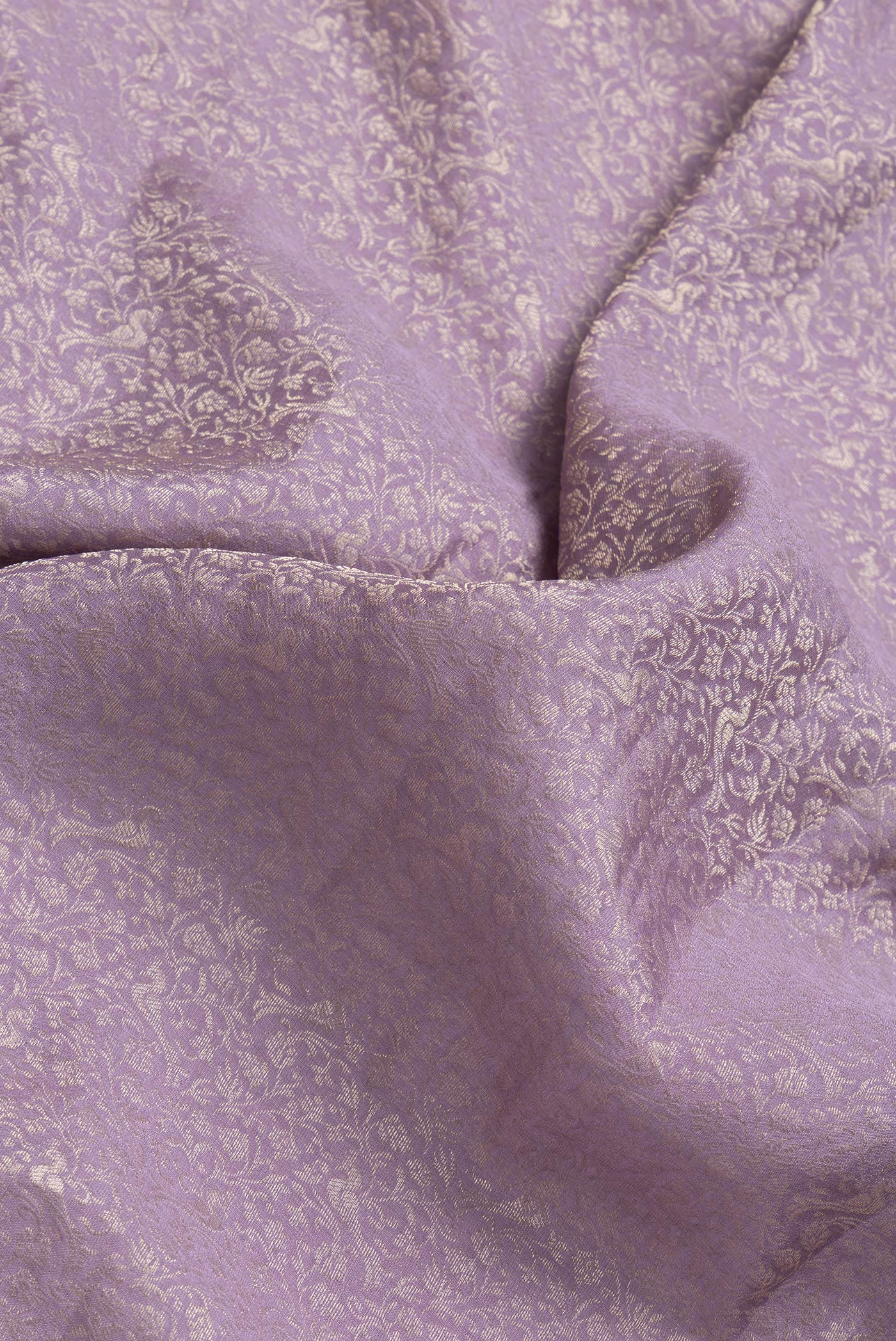 Close up of Lavender Dual Tone Georgette Saree with Zari Brocade on the body and Fancy Border.  displaying folds
