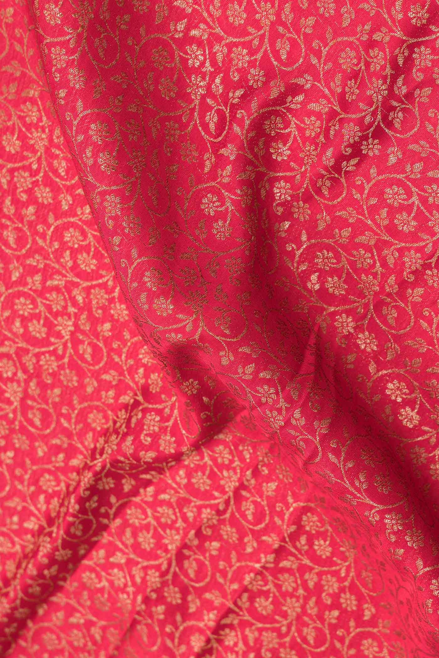 Close up of Pink Dual Tone Banarasi Silk Saree with Zari Brocade on the body and Zari Border.  displaying folds