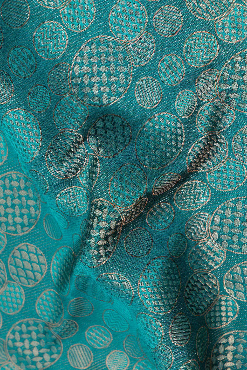 Close up of Teal Crepe Saree with Zari Brocade on the body and Zari Border.  displaying folds