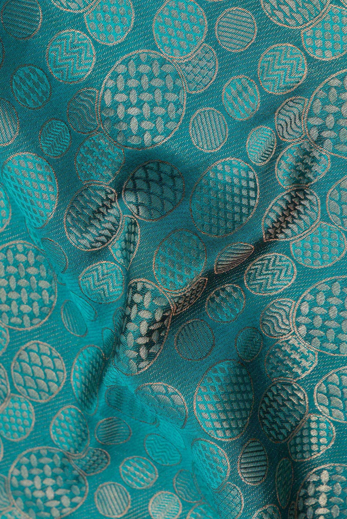 Close up of Teal Crepe Saree with Zari Brocade on the body and Zari Border.  displaying folds