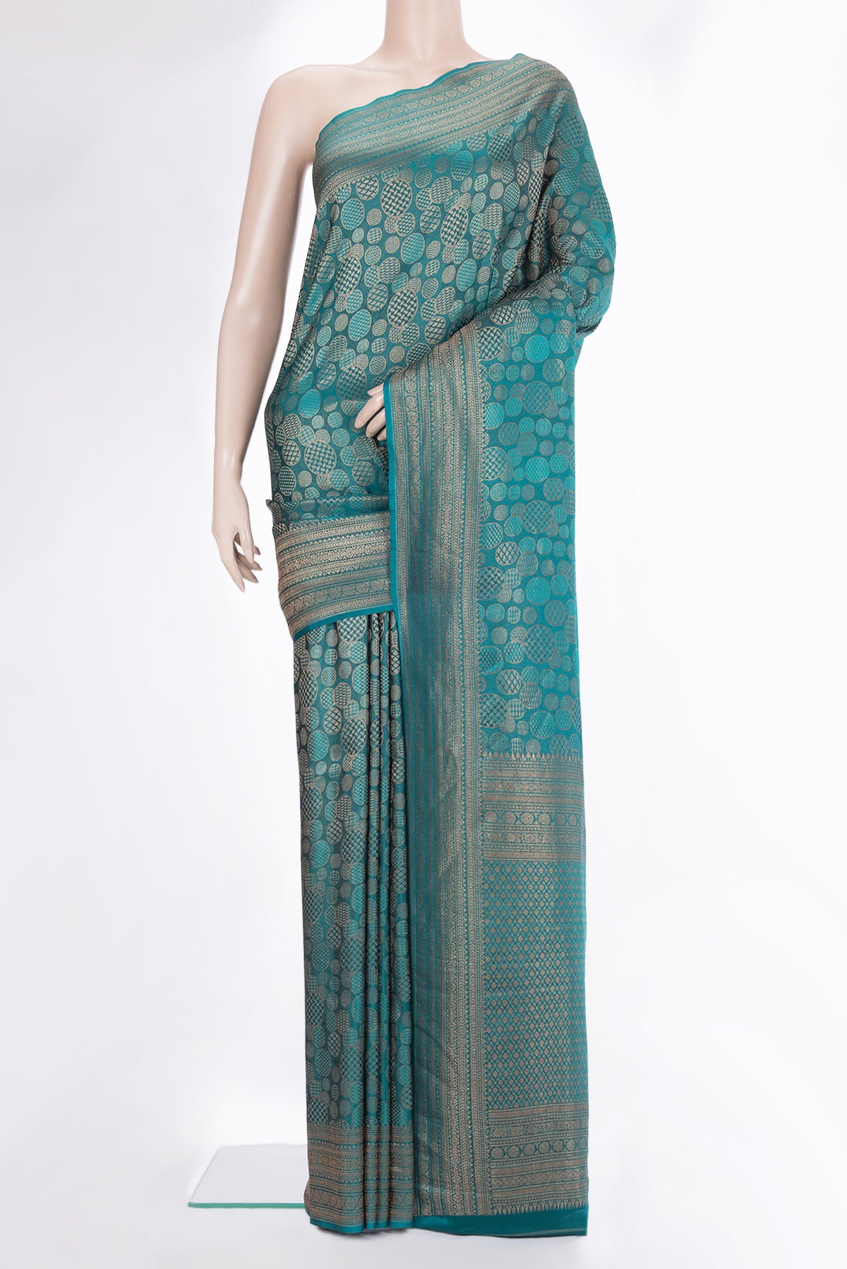 Teal Crepe Saree with Zari Brocade on the body and Zari Border.  displayed on a mannequin