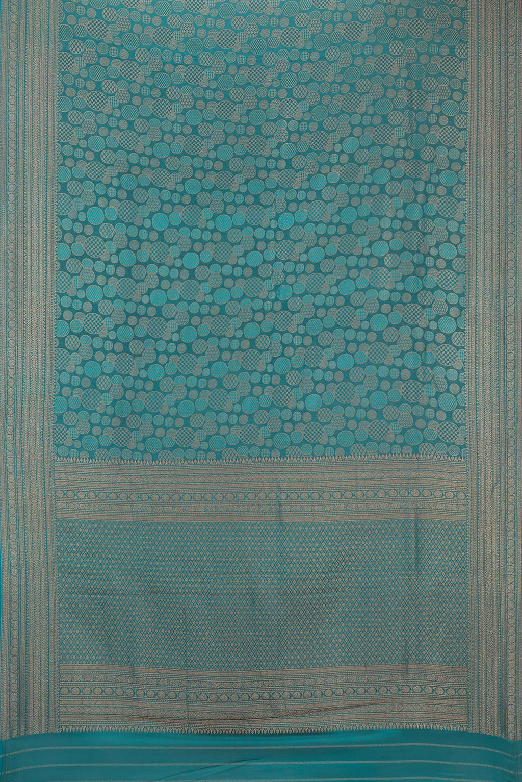Flat view of Teal Crepe Saree with Zari Brocade on the body and Zari Border. 