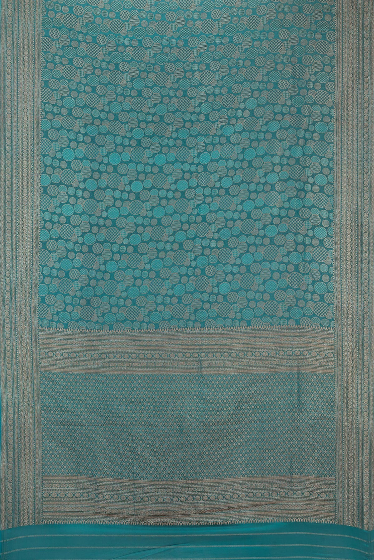 Flat view of Teal Crepe Saree with Zari Brocade on the body and Zari Border. 