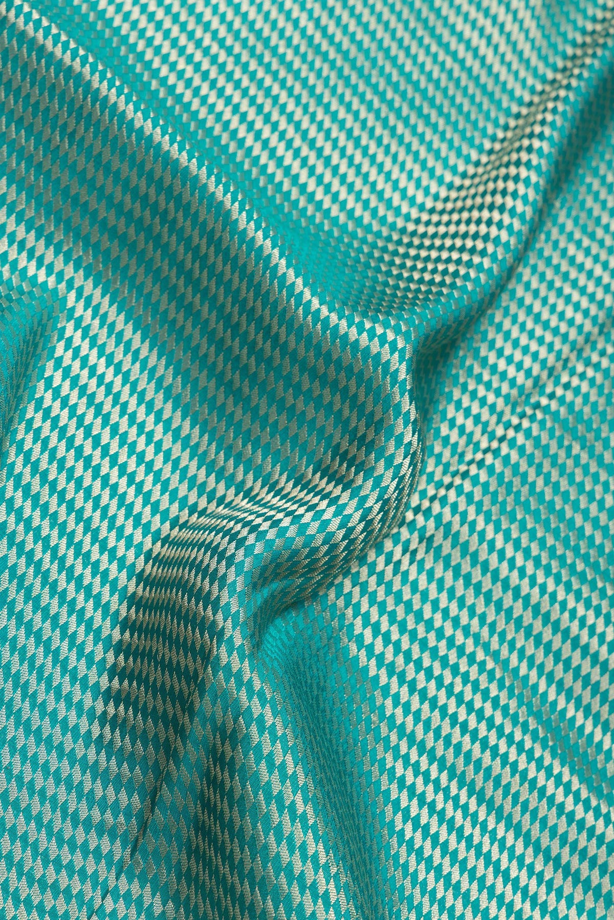 Close up of Sky Blue Dual Tone Banarasi Georgette Saree with Zari Brocade on the body and Zari Border.  displaying folds