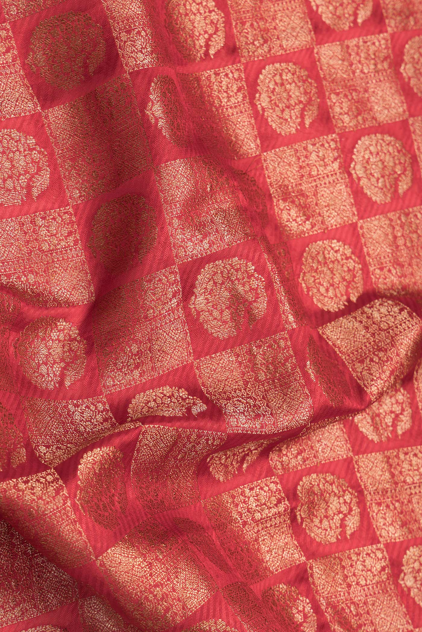 Close up of Red Dual Tone Banarasi Georgette Saree with Zari Brocade on the body and Zari Border.  displaying folds