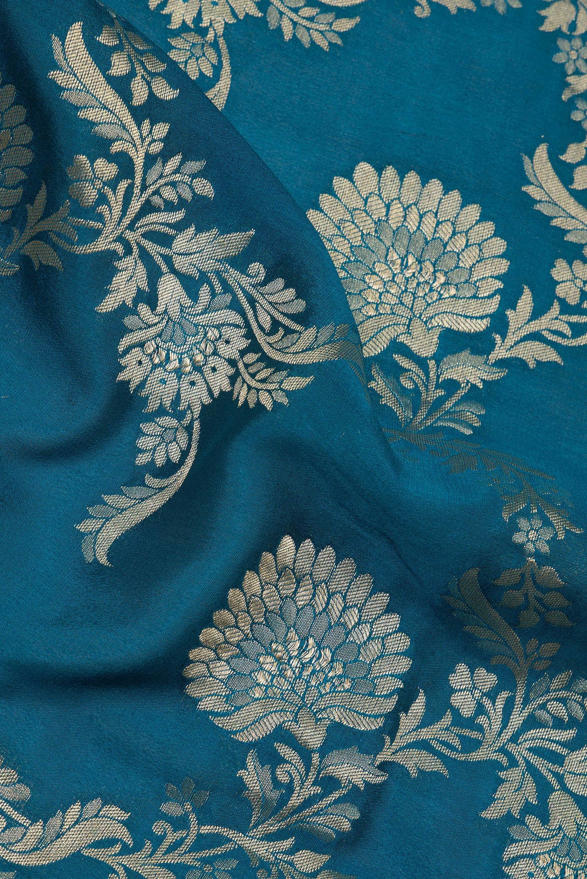 Close up of Peacock Blue Crepe Saree with Zari Brocade on the body and Zari Border.  displaying folds