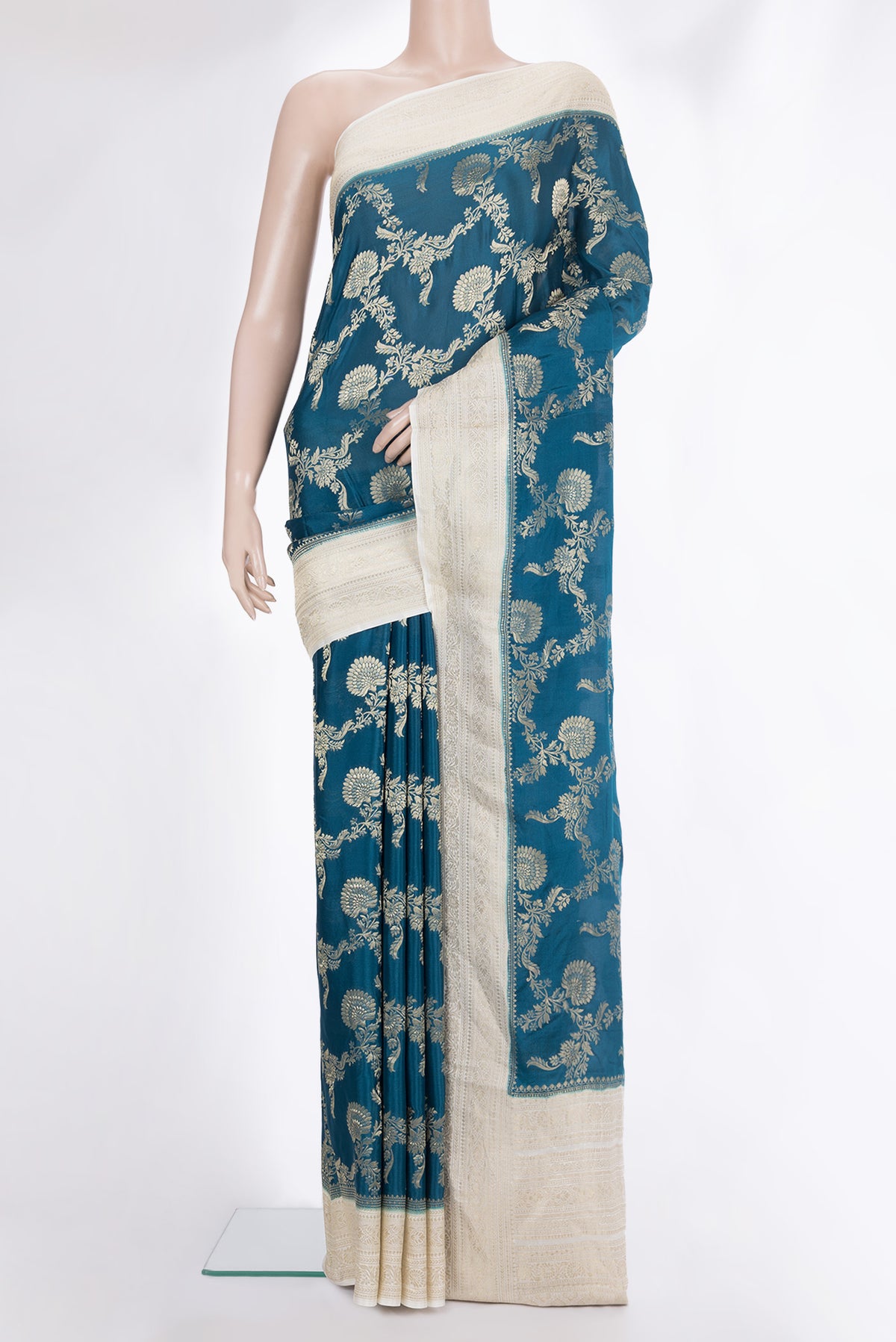 Peacock Blue Crepe Saree with Zari Brocade on the body and Zari Border.  displayed on a mannequin