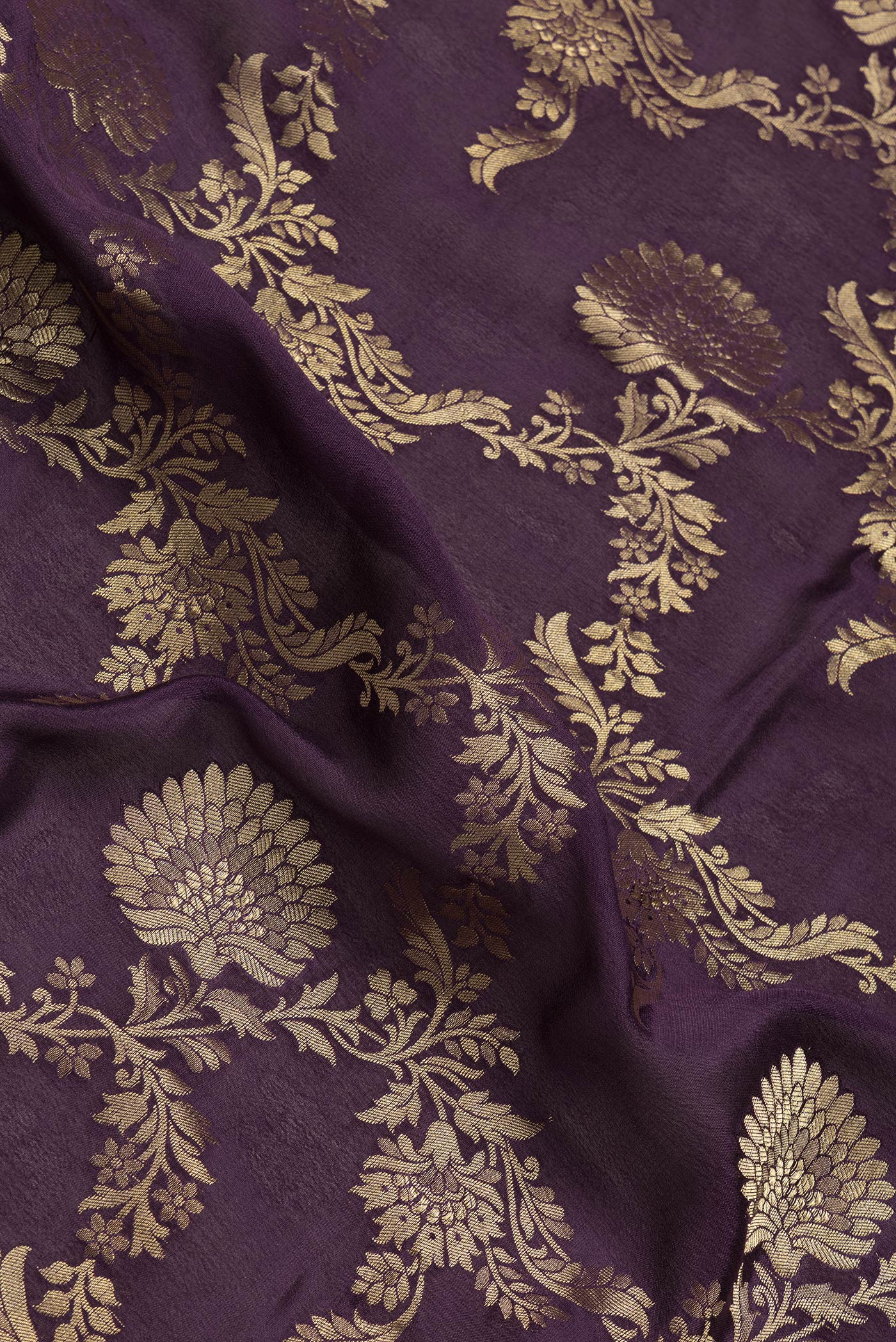 Close up of Burgundy Dual Tone Mysore Georgette Saree with Zari Brocade on the body and Zari Border.  displaying folds