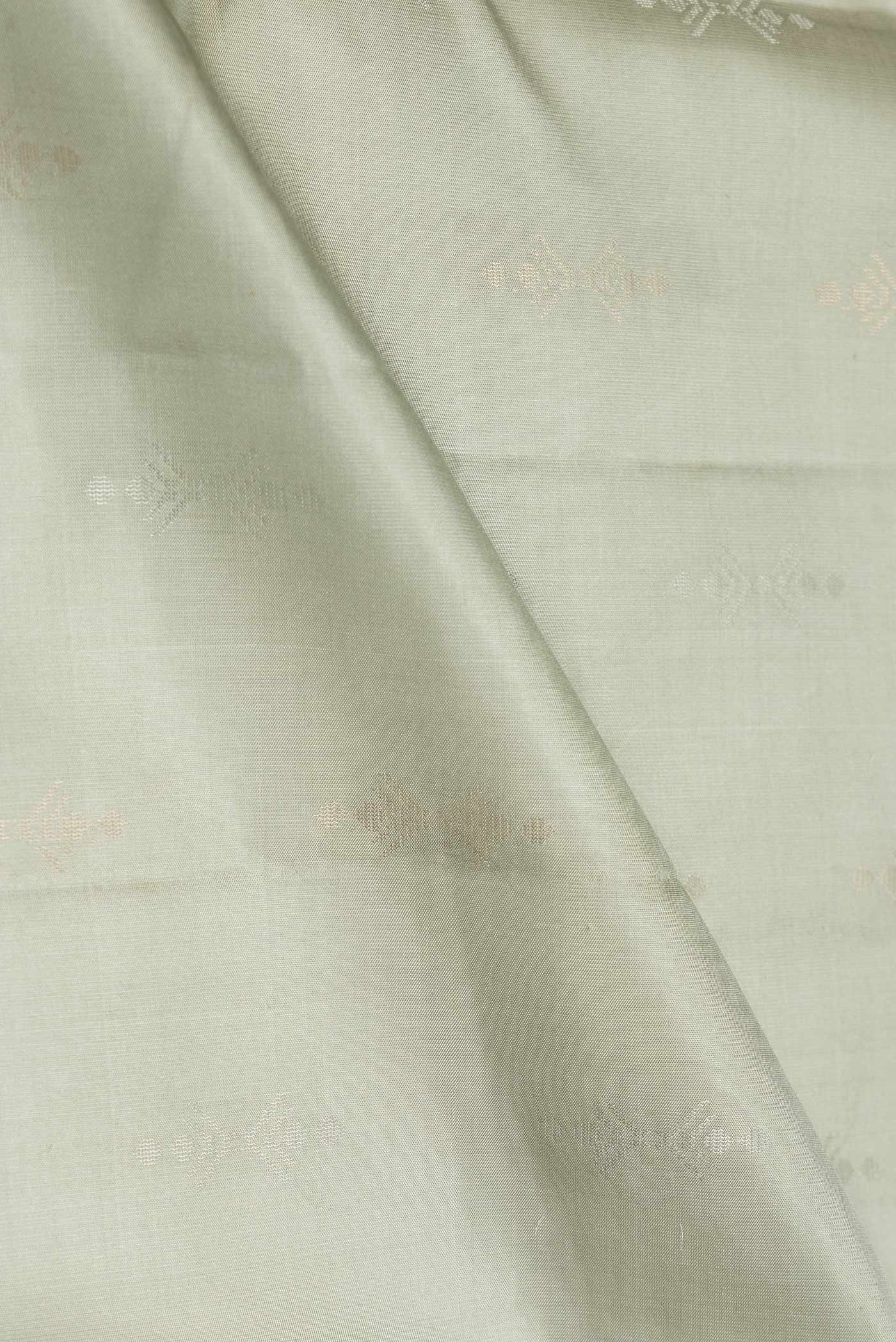 Close up of Pista Green Dual Tone Soft Silk Saree with Zari Butta on the body and Without Border.  displaying folds