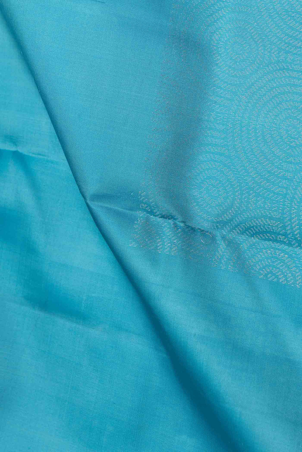Close up of Sky Blue Dual Tone Soft Silk Saree with Zari Butta on the body and Without Border.  displaying folds
