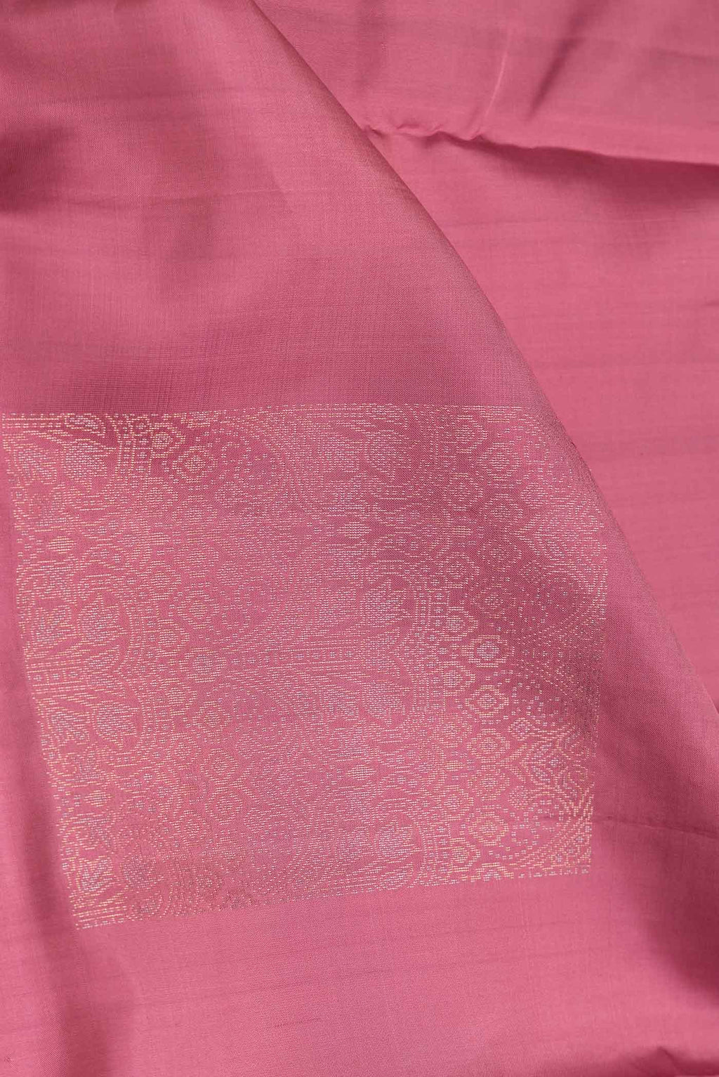 Close up of Pink Dual Tone Soft Silk Saree with Zari Butta on the body and Without Border.  displaying folds