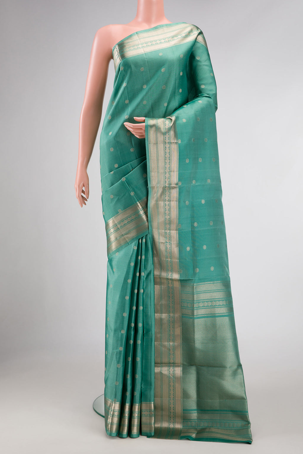Green Dual Tone Soft Silk Saree with Zari Butta on the body and Zari Border.  displayed on a mannequin