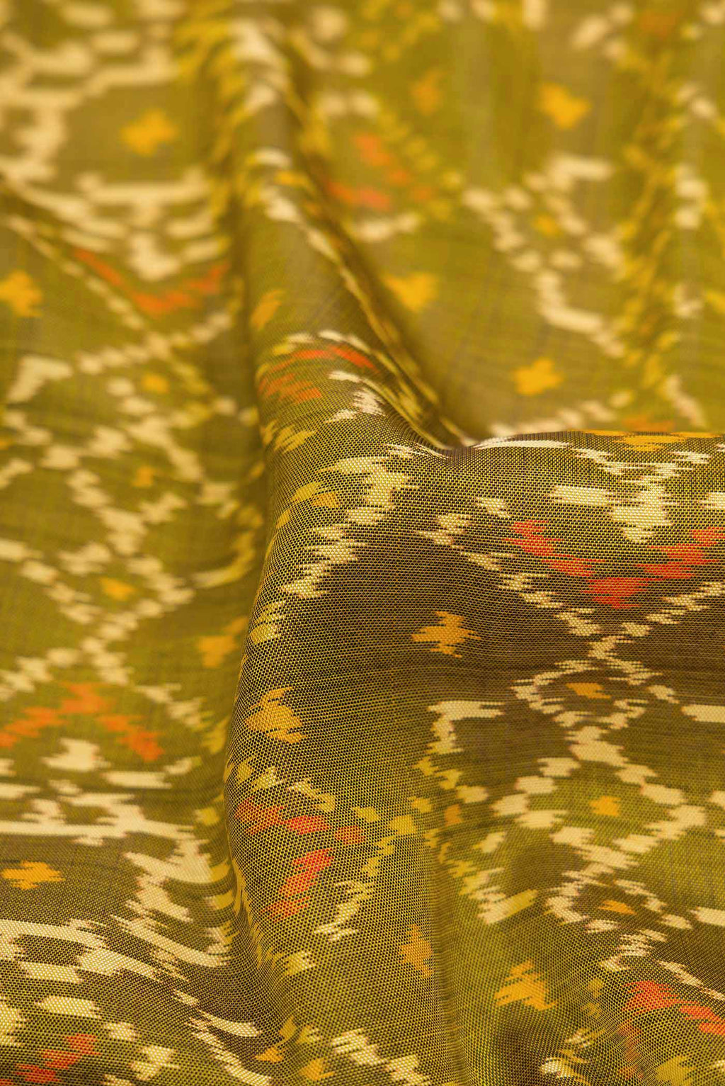 Close up of Mehandi Green Dual Tone Rajkot Patola Silk Saree with Ikat Print on the body and Ikat Border displaying folds