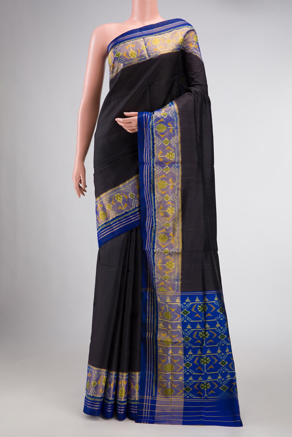 Black Dual Tone Rajkot Patola Silk Saree with Plain Body and Ikat Border displayed on a mannequin