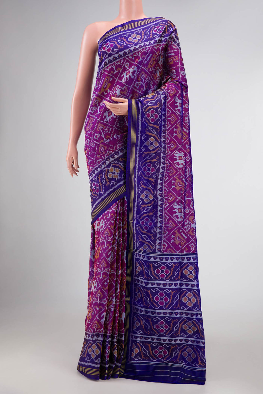 Purple Dual Tone Rajkot Patola Silk Saree with Ikat Print on the body and Ikat Border displayed on a mannequin