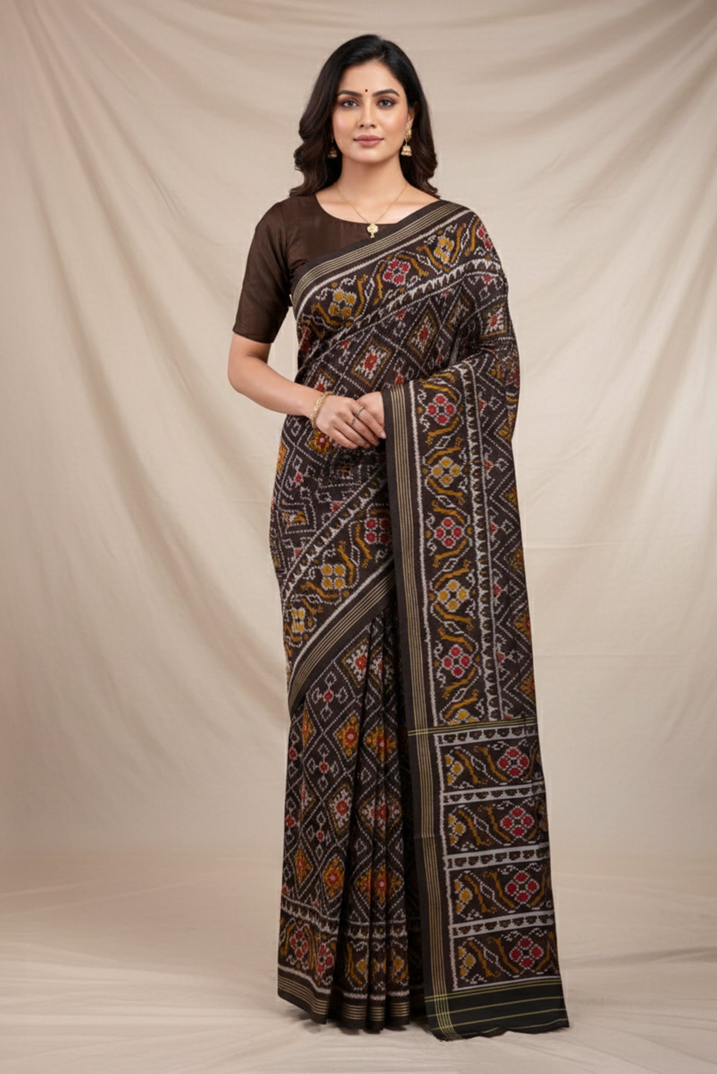 Model wearing a Black Pochampally Silk Saree with Pure Ikat on the body and Plain Border