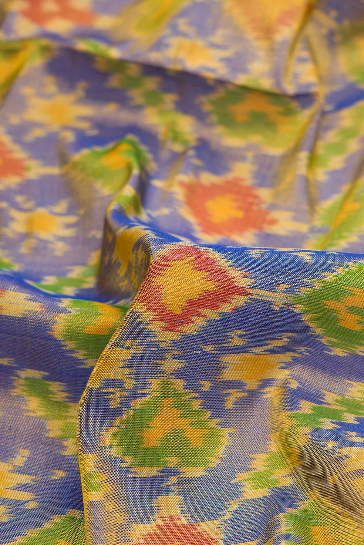 Close up of Lavender Dual Tone Rajkot Patola Silk Saree with Ikat Print on the body and Ikat Border displaying folds
