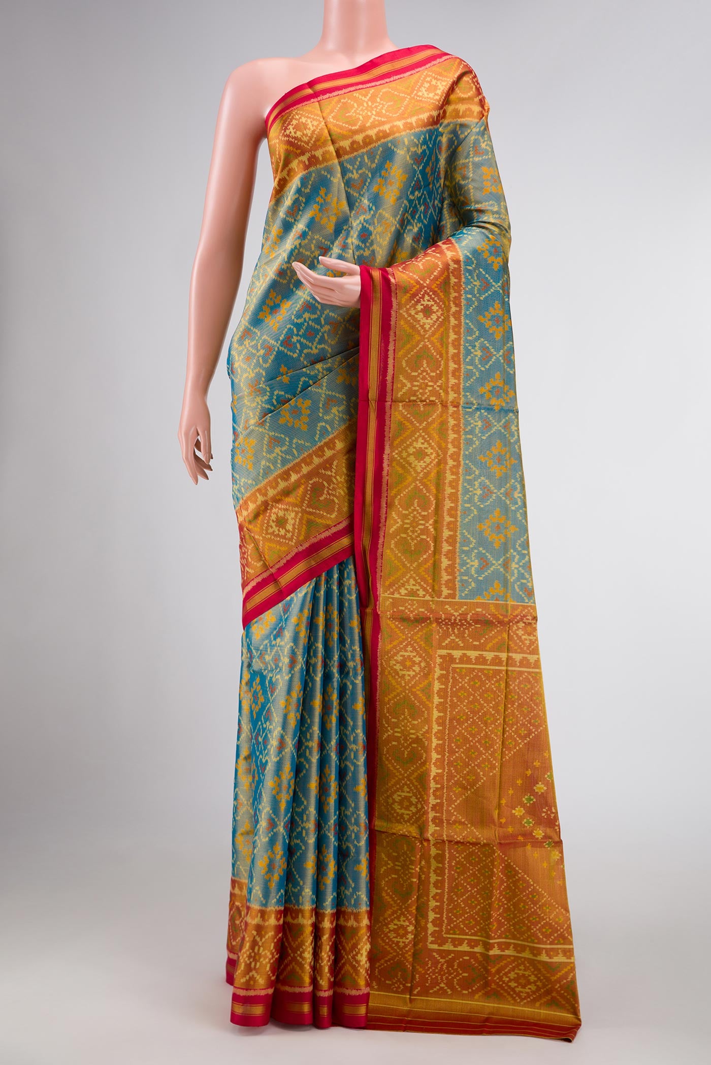 Light Blue Dual Tone Rajkot Patola Silk Saree with Ikat Print on the body and Zari Border displayed on a mannequin