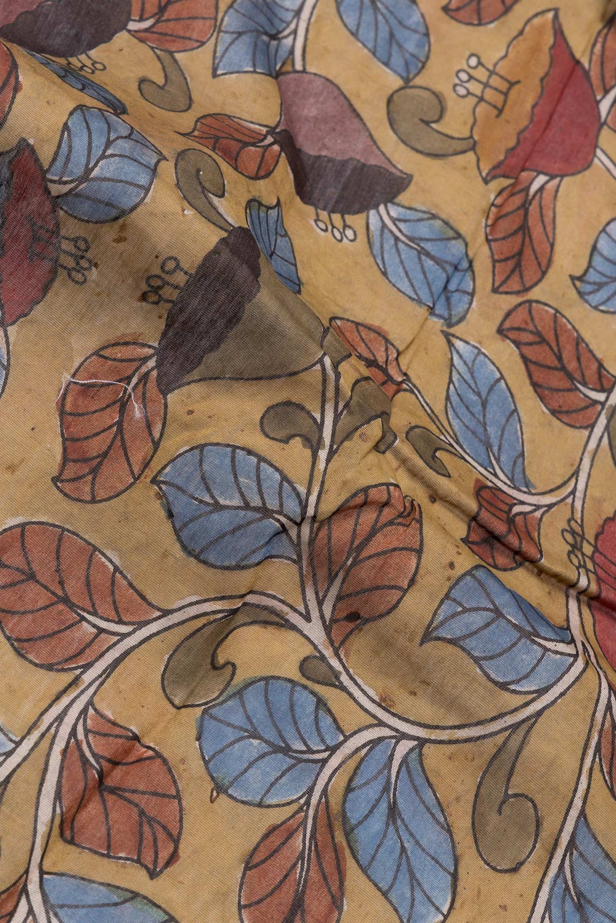 Close up of Mehandi Green Dual Tone Tussar Silk Saree with Printed design on the body and Plain Border.  displaying folds