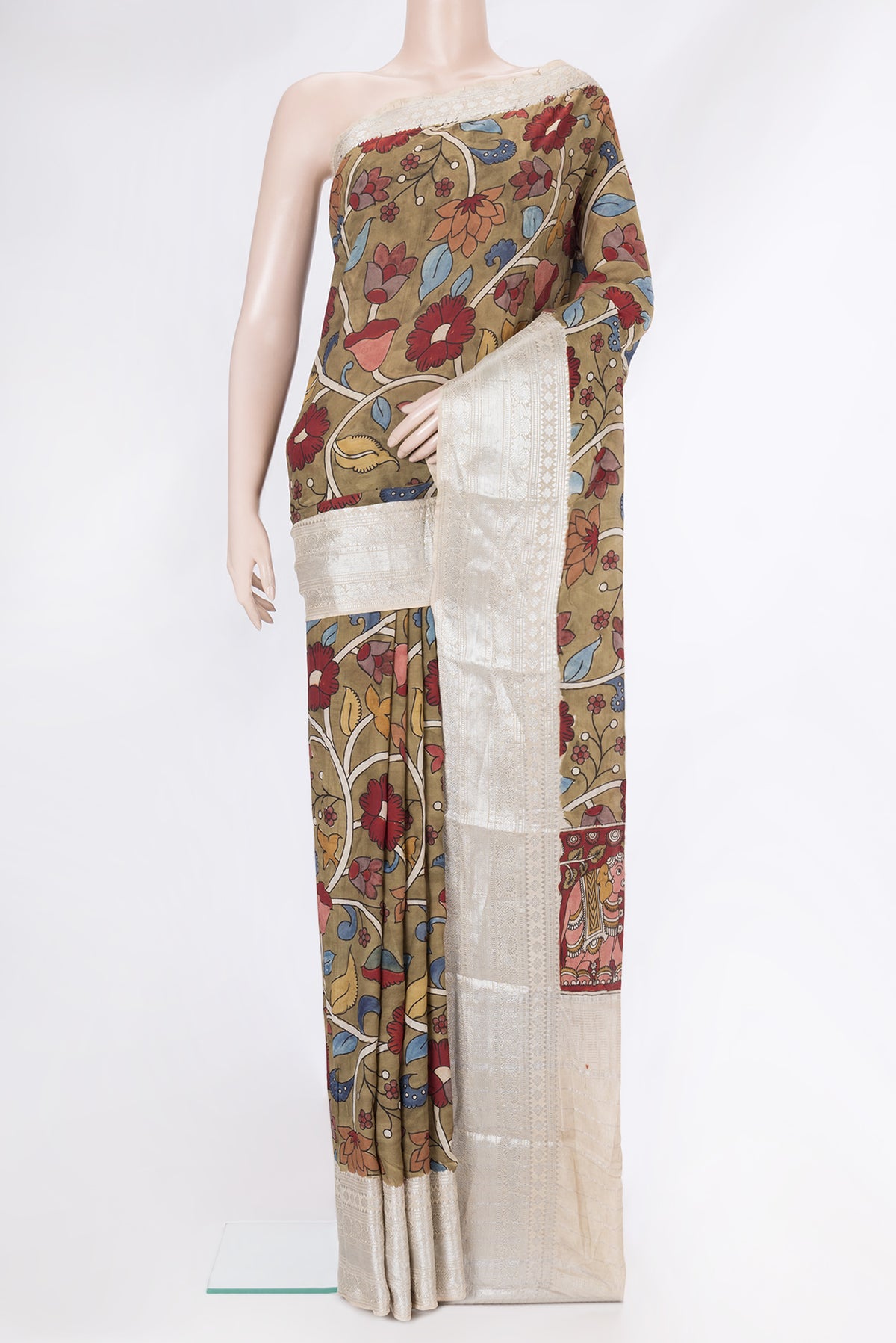 Brown Tussar Silk Saree with kalamkari Print on the body and Zari Border.  displayed on a mannequin