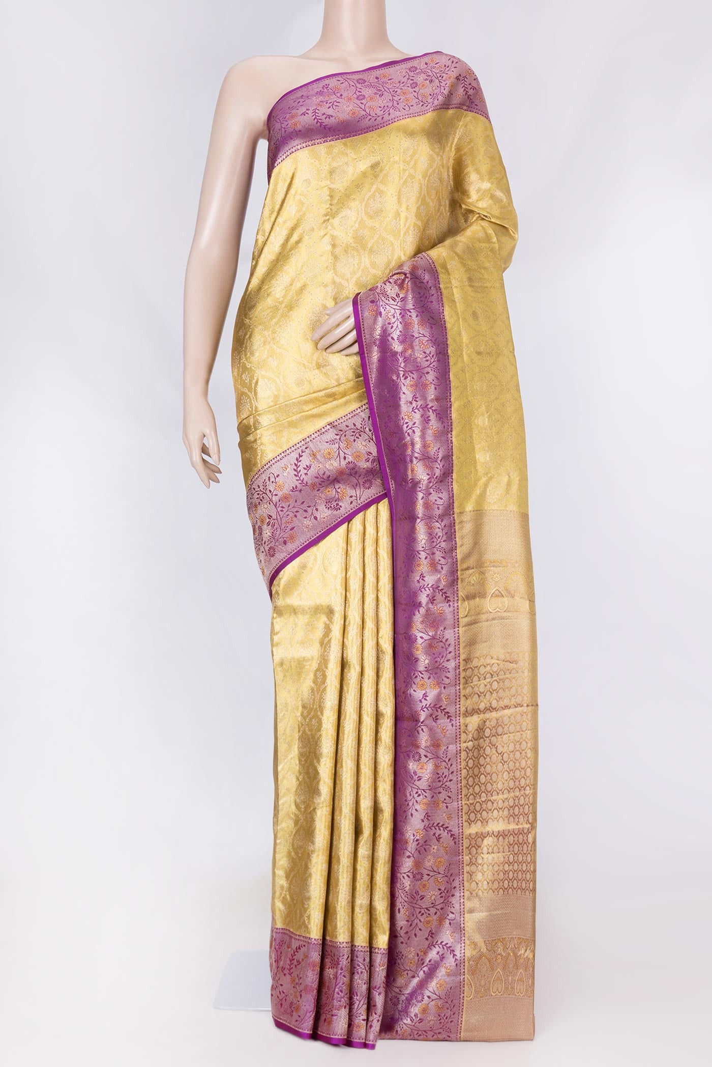 Gold Dual Tone Kanchipuram Saree with Zari Brocade on the body and Zari Border displayed on a mannequin