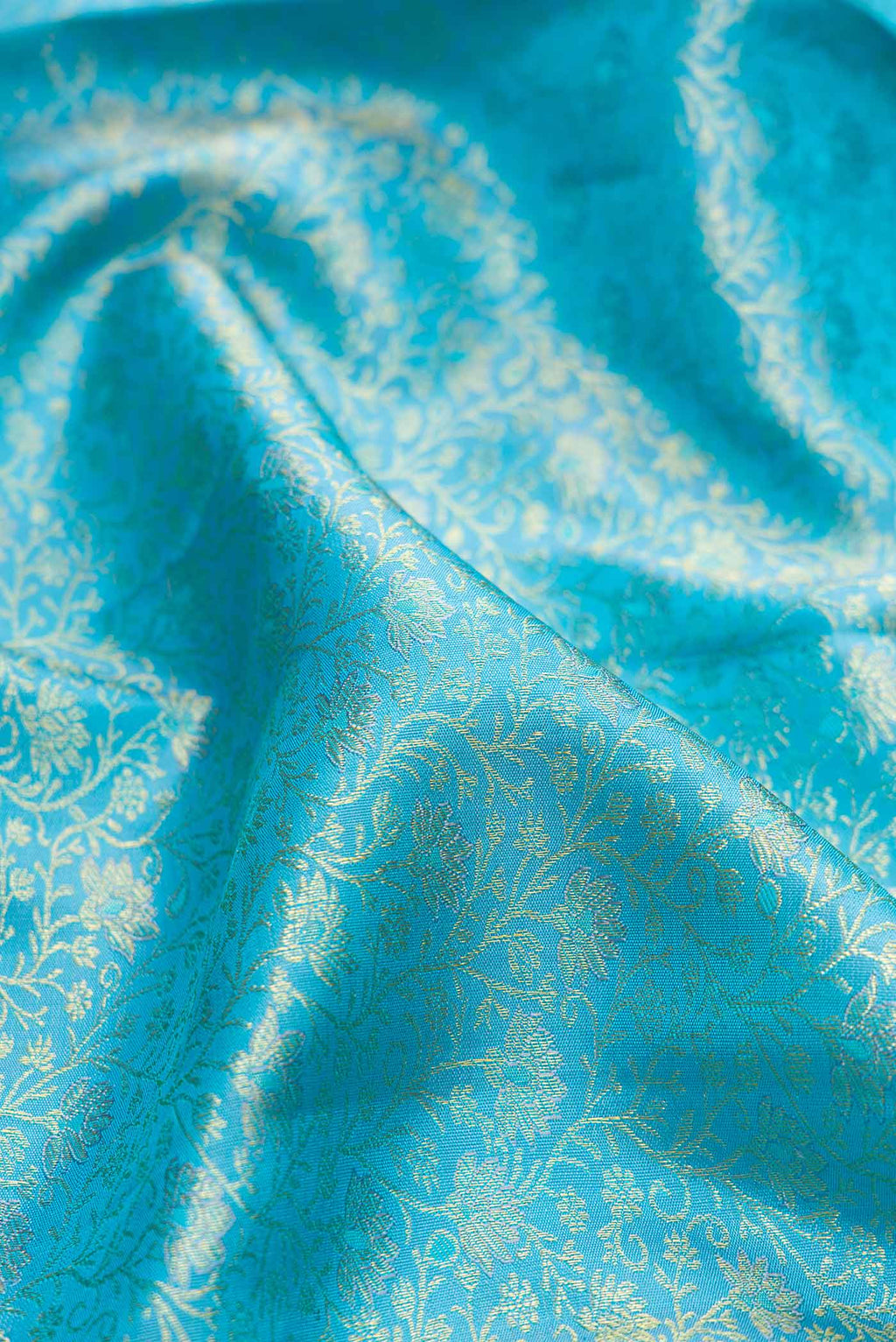 Close up of Sky Blue Dual Tone Kanchipuram Silk Saree with Zari Brocade on the body and Zari Border.  displaying folds
