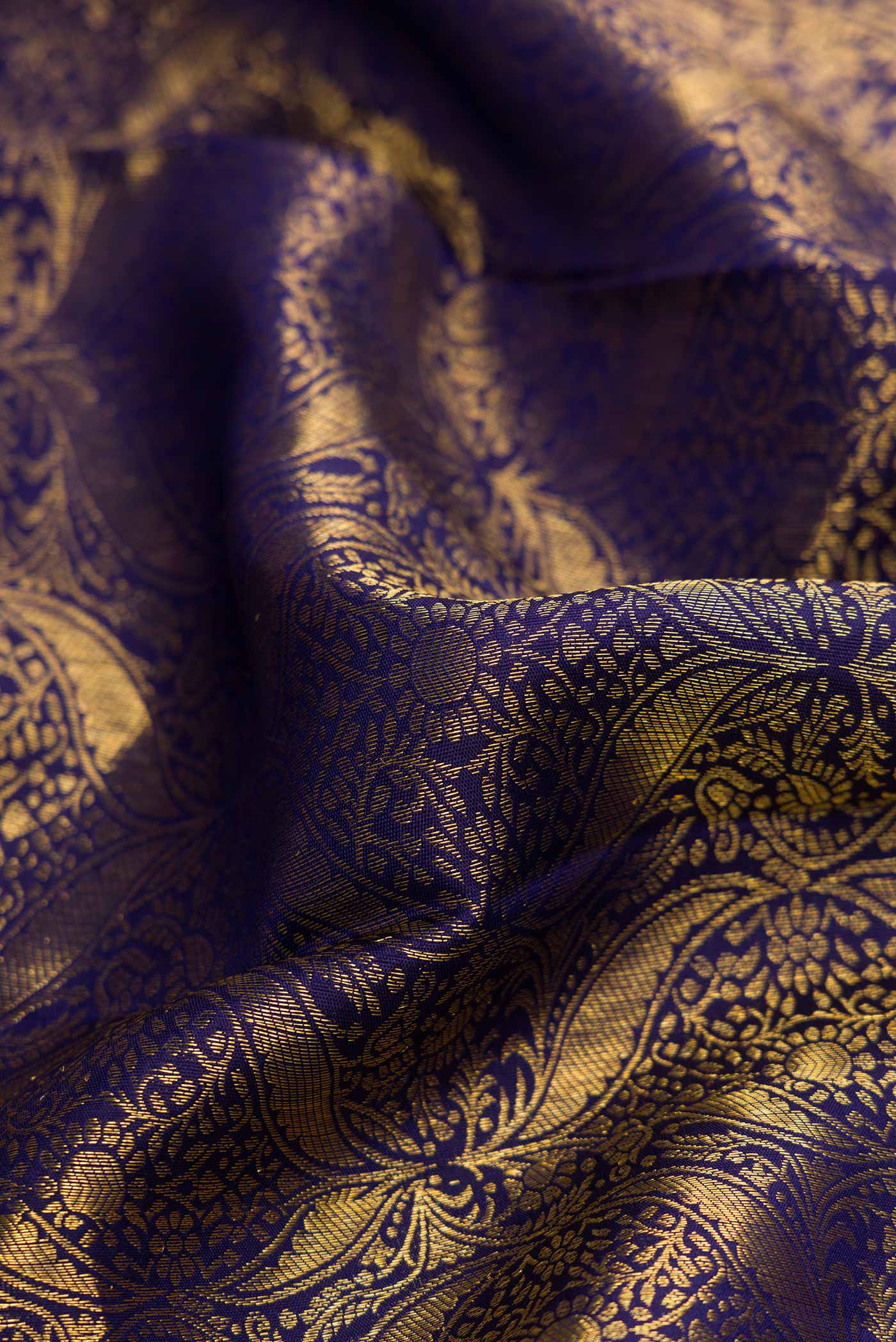 Close up of Navy Blue Dual Tone Kanchipuram Silk Saree with Zari Brocade on the body and Zari Border.  displaying folds