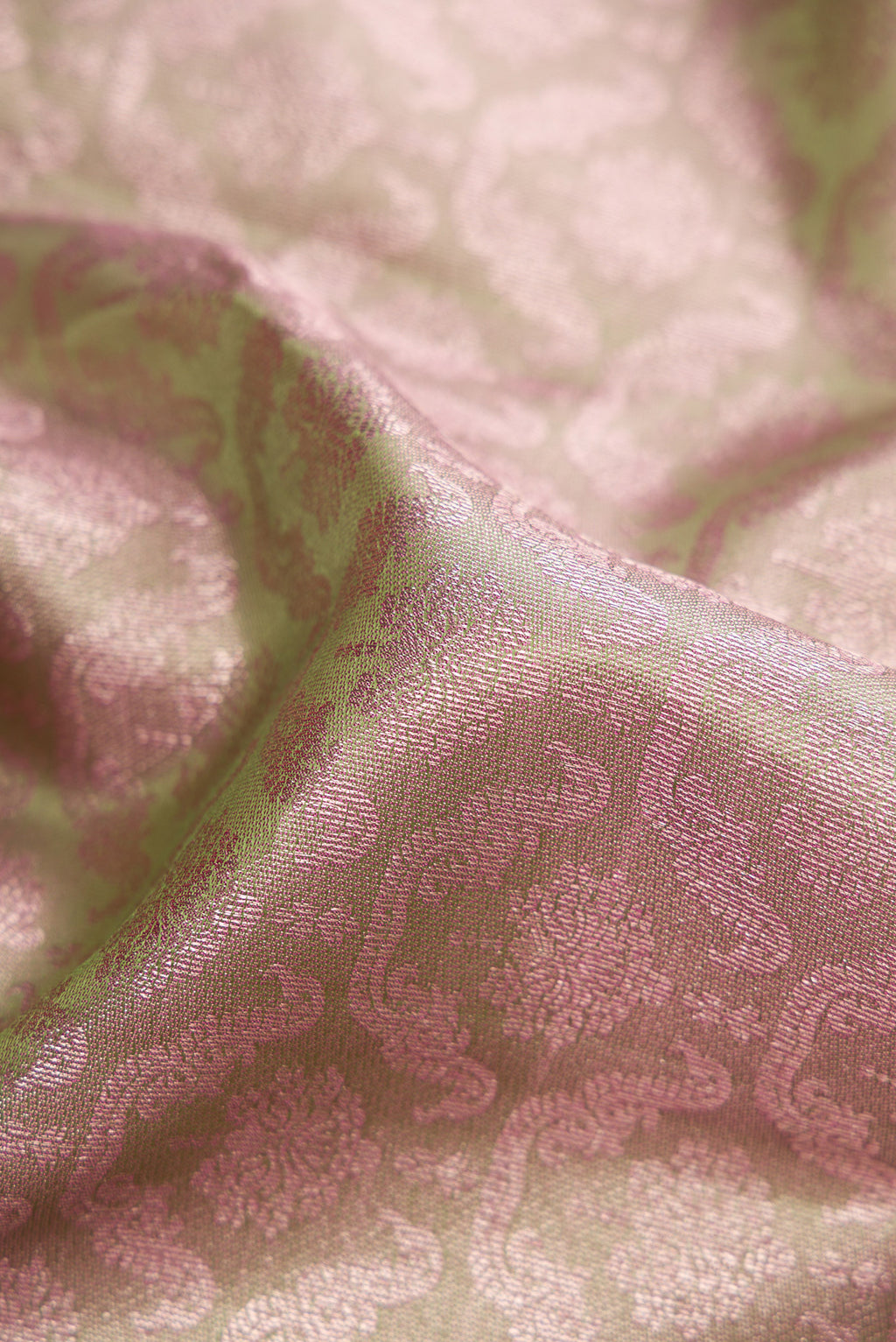 Close up of Pista Green Dual Tone Kanjivaram Silk Saree with Zari Brocade on the body and Zari Border.  displaying folds