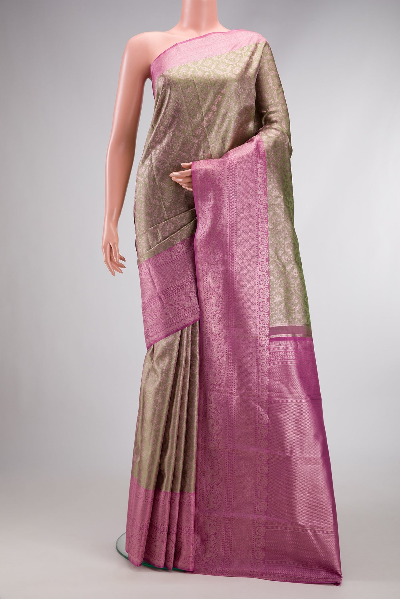 Pista Green Dual Tone Kanjivaram Silk Saree with Zari Brocade on the body and Zari Border.  displayed on a mannequin