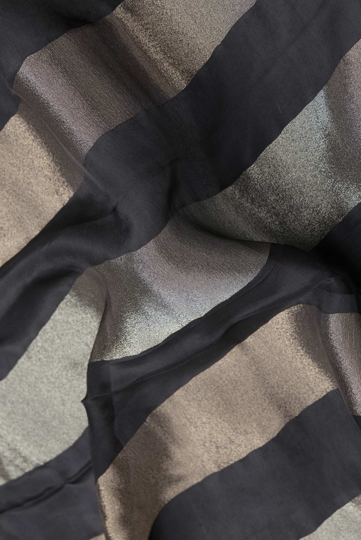 Close up of Black Dual Tone Banarasi Georgette Saree with Stripes on the body and Embroidery Border.  displaying folds