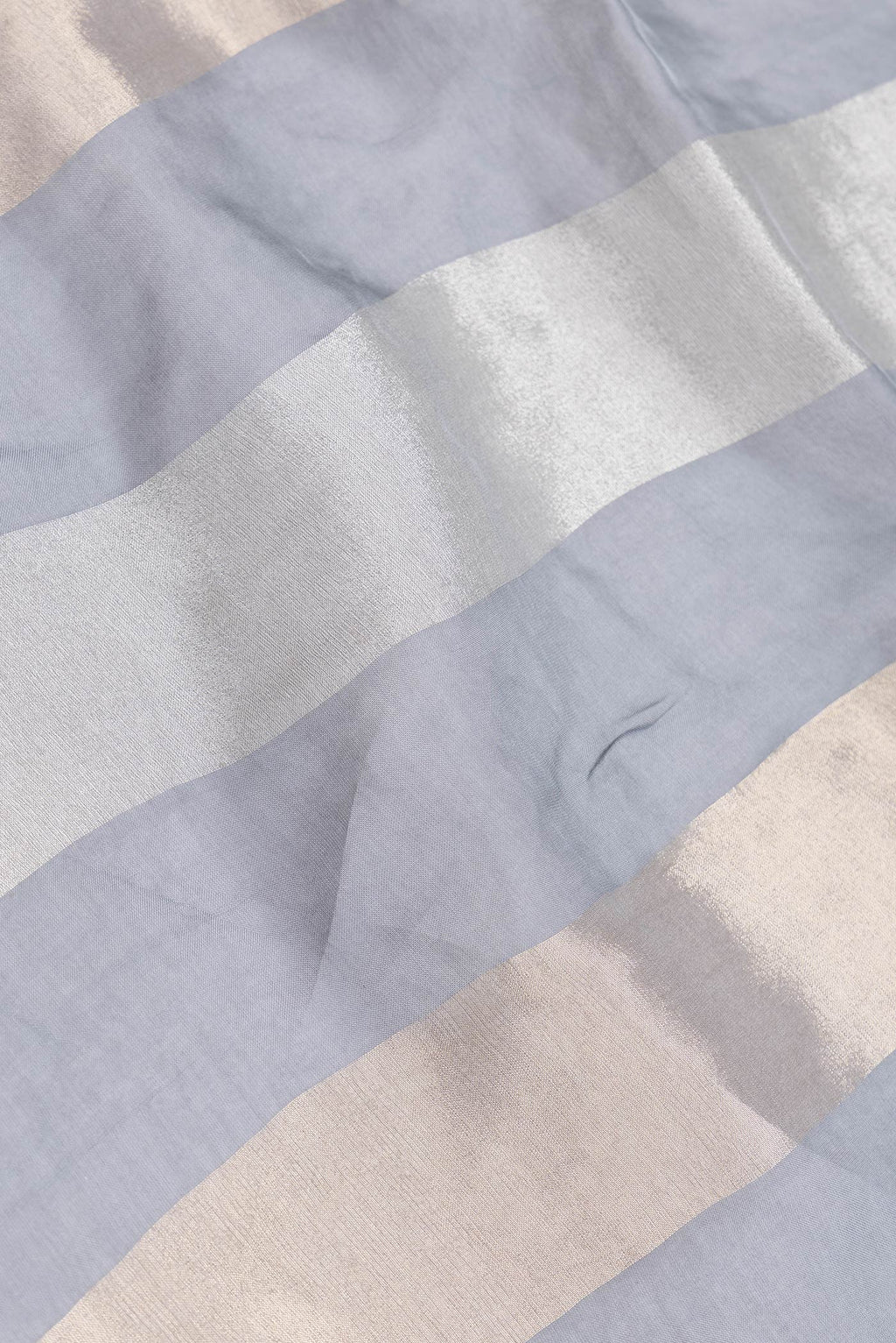 Close up of Grey Dual Tone Mysore Georgette Saree with Stripes on the body and Embroidery Border.  displaying folds