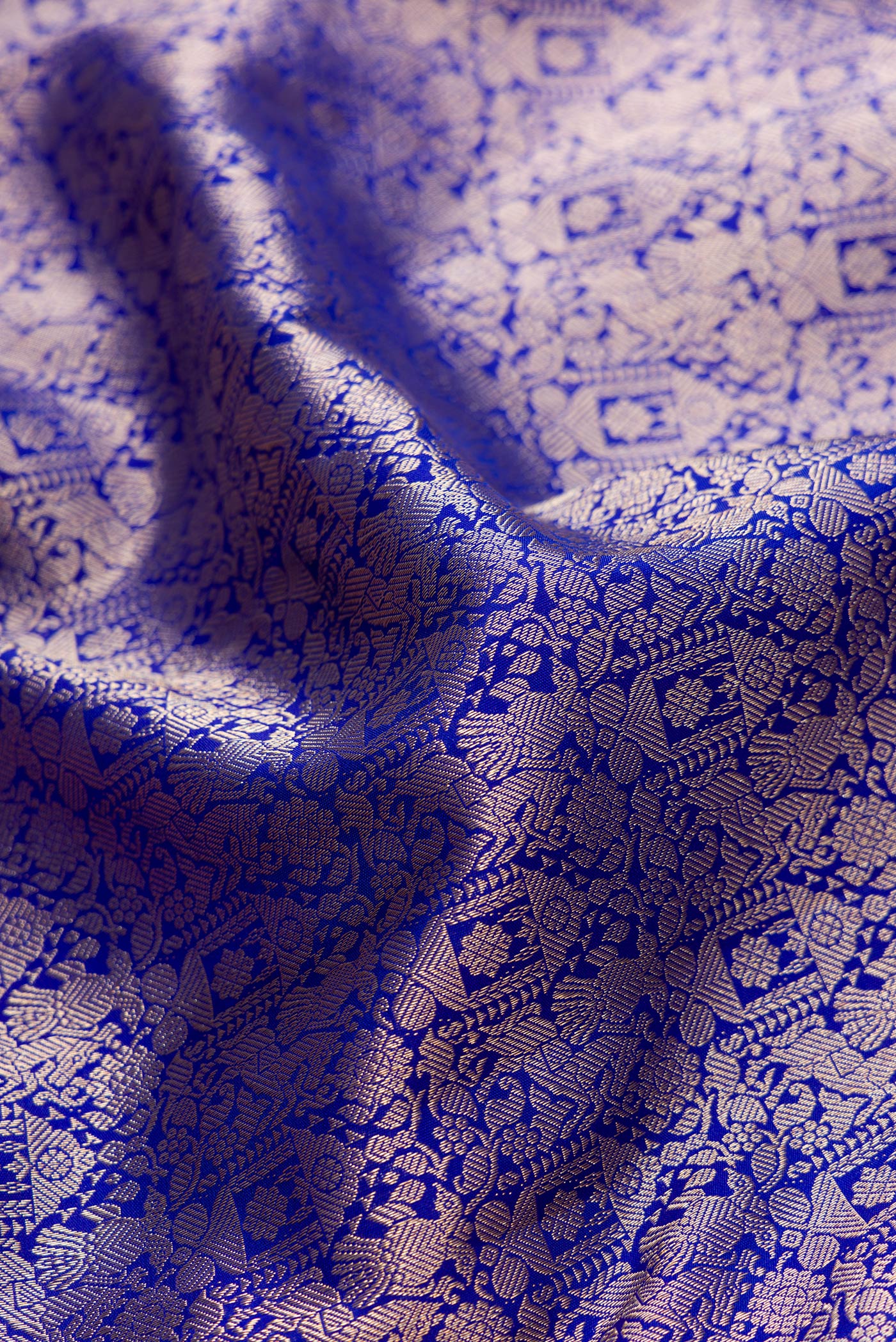 Close up of Royal Blue Dual Tone Kanjivaram Silk Saree with Zari Brocade on the body and Zari Border.  displaying folds