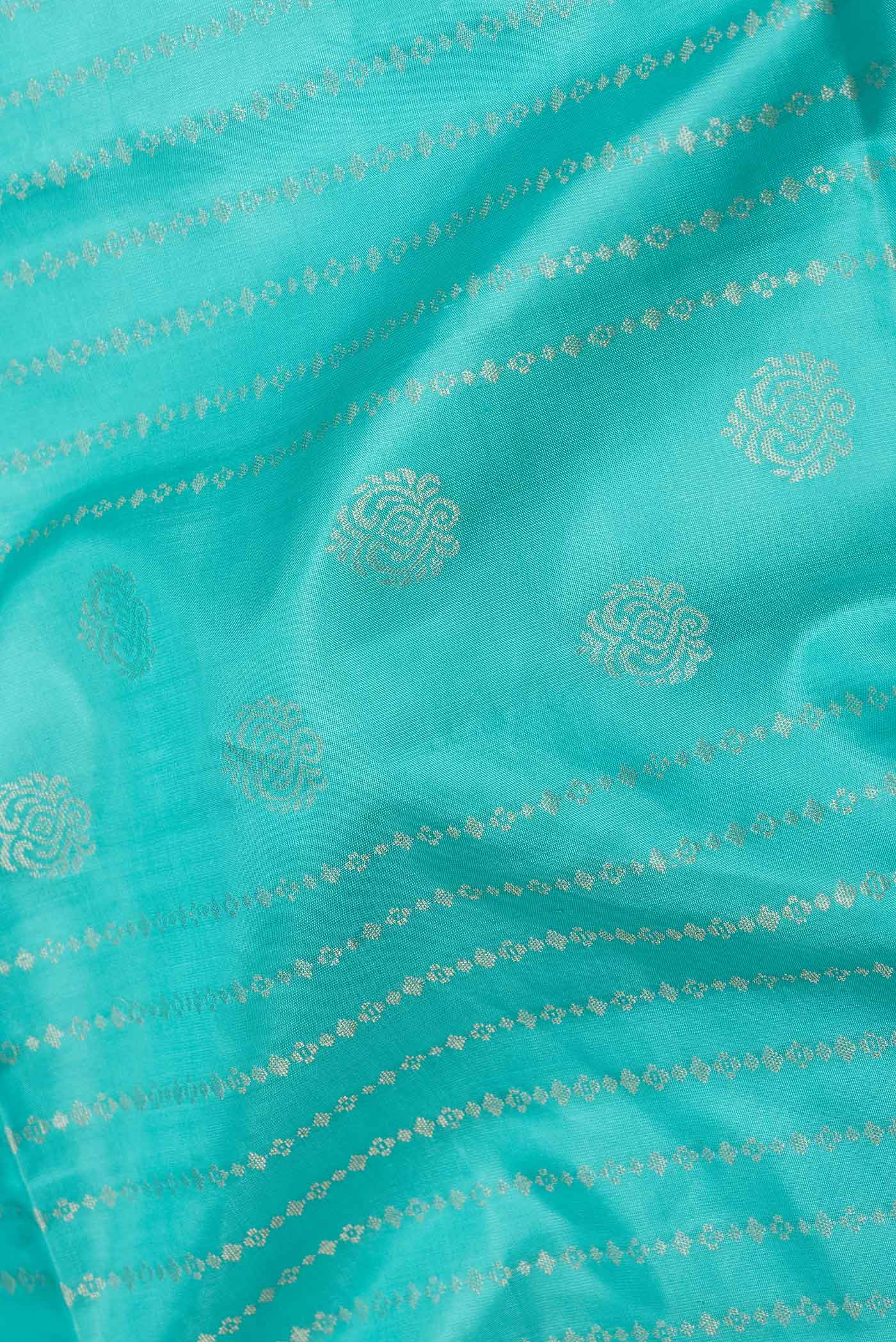 Close up of Sky Blue Dual Tone Soft Silk Saree with Zari Butta on the body and Fancy Border displaying folds