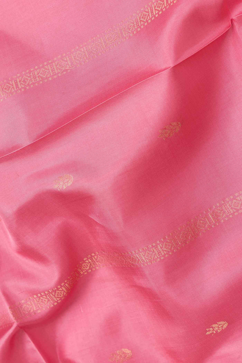 Close up of Pink Dual Tone Soft Silk Saree with Zari Butta on the body and Zari Border.  displaying folds