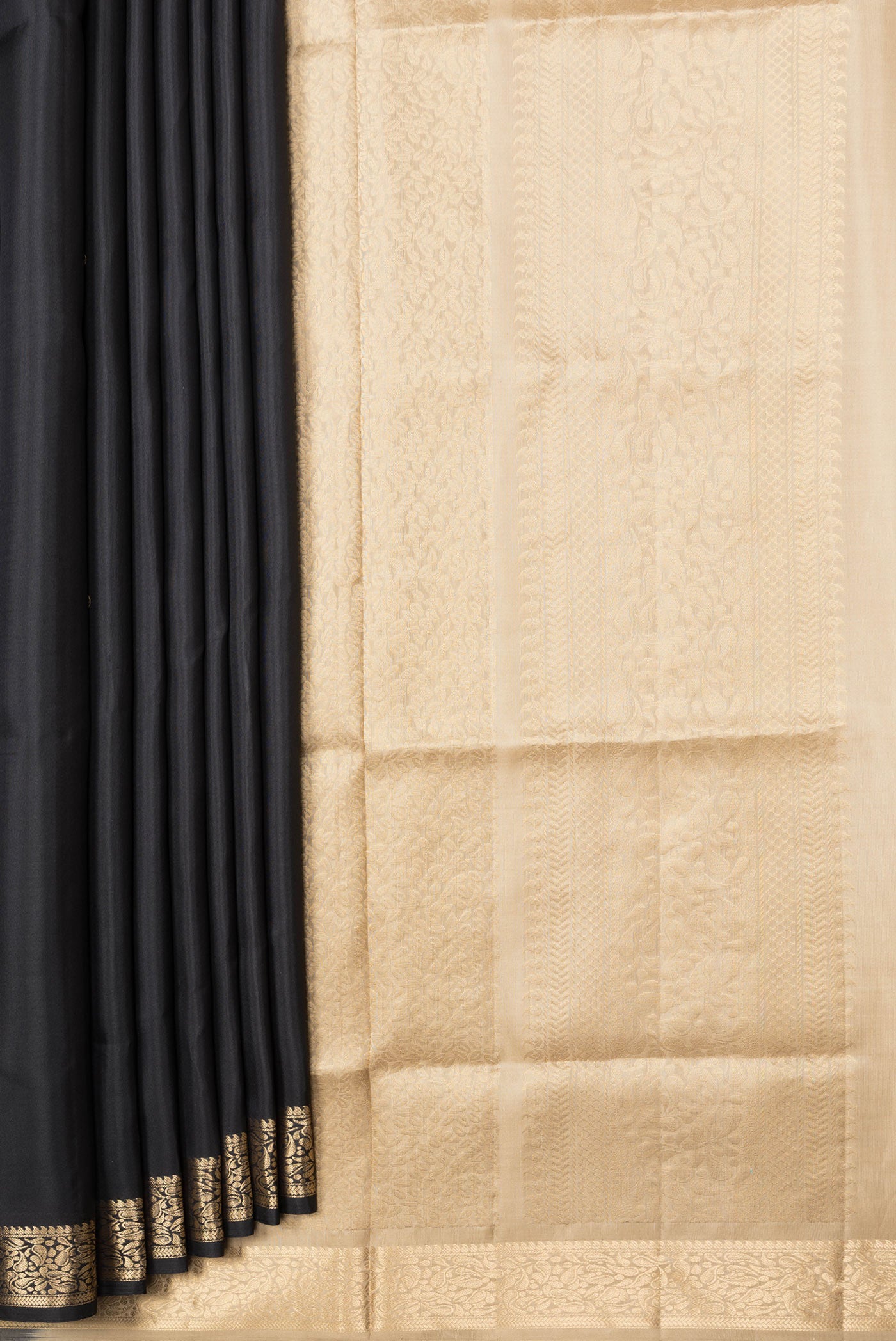 Pleats and pallu of Black Dual Tone Soft Silk Saree with Zari Butta on the body and Zari Border. 