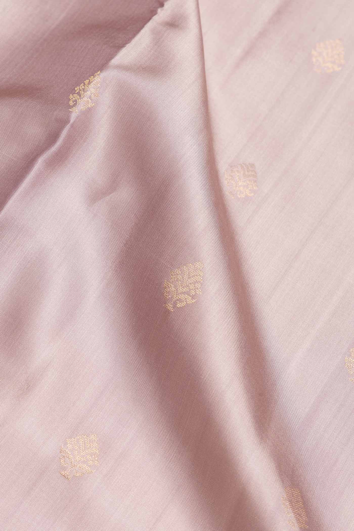 Close up of Rose Gold Dual Tone Soft Silk Saree with Zari Butta on the body and Zari Border.  displaying folds
