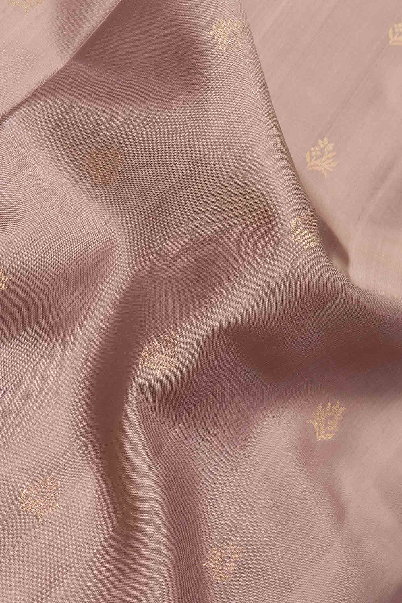 Close up of Beige Dual Tone Soft Silk Saree with Zari Butta on the body and Zari Border.  displaying folds