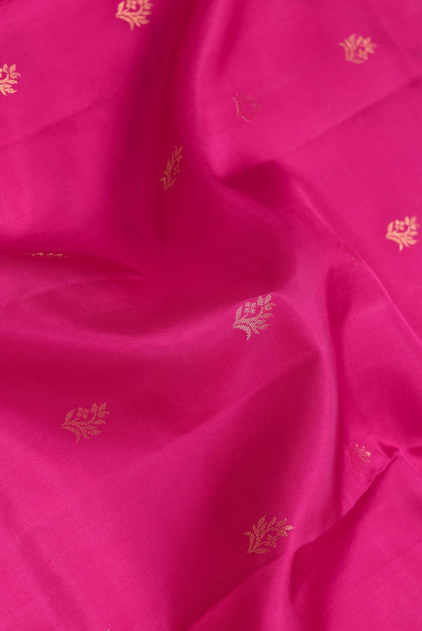 Close up of Dark Pink Dual Tone Soft Silk Saree with Zari Butta on the body and Zari Border.  displaying folds